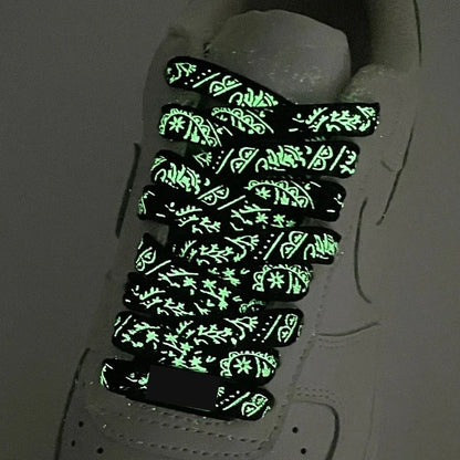 Luminous printed shoelaces glowing on sneakers at night