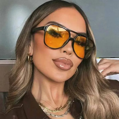 Woman wearing tortoiseshell aviator sunglasses with yellow lens